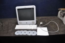 AN APPLE eMAC E1002 EMC 1955 PERSONAL COMPUTER with keyboard, User Guide and five software discs (