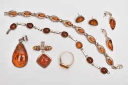 A SMALL BAG OF AMBER SET JEWELLERY, to include a silver amber cabochon set ring, hallmarked London