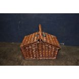 A MODERN WICKER PICNIC BASKET with crockery and cutlery inside (looks unused)