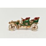 AN EARLY 20TH CENTURY GOLD CAR BROOCH, yellow gold brooch with red, green and white enamel detail,