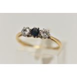 A YELLOW METAL DIAMOND AND SAPPHIRE THREE STONE RING, designed with a central circular cut blue