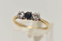 A YELLOW METAL DIAMOND AND SAPPHIRE THREE STONE RING, designed with a central circular cut blue