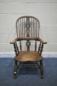 A 19TH CENTURY ELM WINDSOR ARMCHAIR, with spindled backrest, turned supports and legs, united by