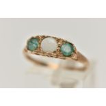 A 9CT GOLD OPAL AND EMERALD RING, set with a central circular opal cabochon, flanked with two