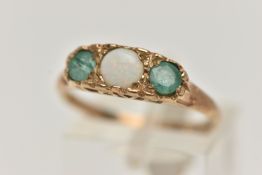A 9CT GOLD OPAL AND EMERALD RING, set with a central circular opal cabochon, flanked with two