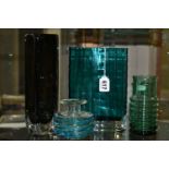 FOUR PIECES OF COLOURED STUDIO GLASS, comprising a navette shaped teal coloured vase with fluted