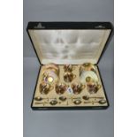 A CASED SET OF SIX ROYAL WORCESTER COFFEE CUPS AND SAUCERS AND SIX SILVER GILT COFFEE SPOONS, the