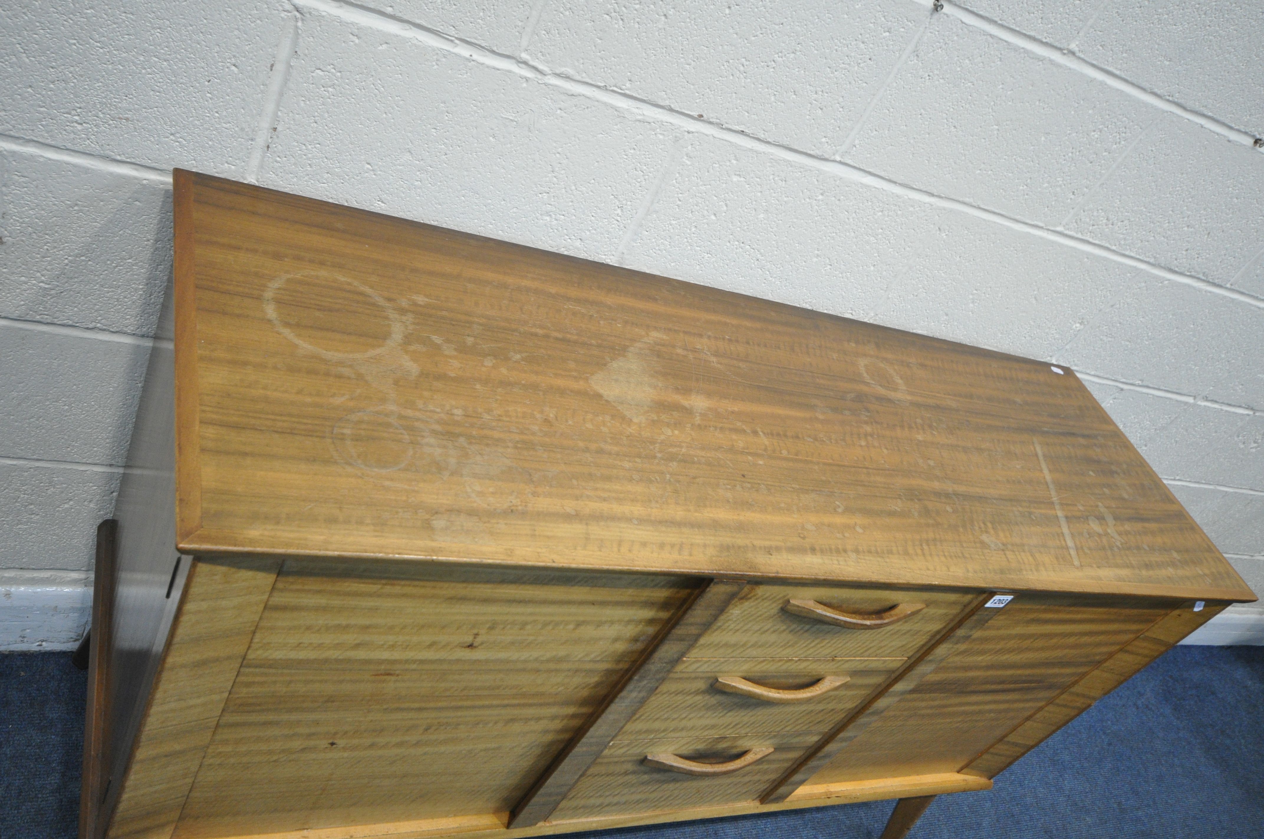 A MID CENTURY ALFRED COX TEAK SIDEBOARD, with two cupboard doors, flanking three drawers, the top - Image 3 of 7