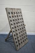 A VINTAGE OAK A STANDING WINE RACK, with sixty bottle holders, width 80cm x height 150cm (