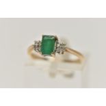 A 9CT GOLD EMERALD AND DIAMOND RING, set with a rectangular cut emerald, four claw set, flanked with