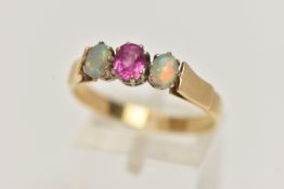 A RUBY AND OPAL RING, a principle set oval cut ruby, set with two oval opals, prong set in yellow