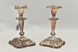 A PAIR OF SILVER PLATE CANDLE STICKS, silver on copper candle sticks, weighted square bases, with