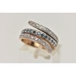 A 9CT GOLD DIAMOND RING, cross over design with a central row of treated blue diamonds, between