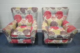 A PAIR OF MODERN FLORAL UPHOLSTERED SWIVEL ARMCHAIRS (condition report: -dirty and stained