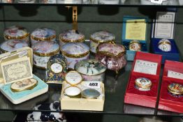 A COLLECTION OF ENAMELLED PILL BOXES, seven boxed Halcyon Days pill boxes comprising 1996 Year of