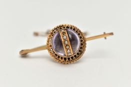 A VICTORIAN BROOCH, principal cabochon amethyst, decorated with a centrally positioned band of