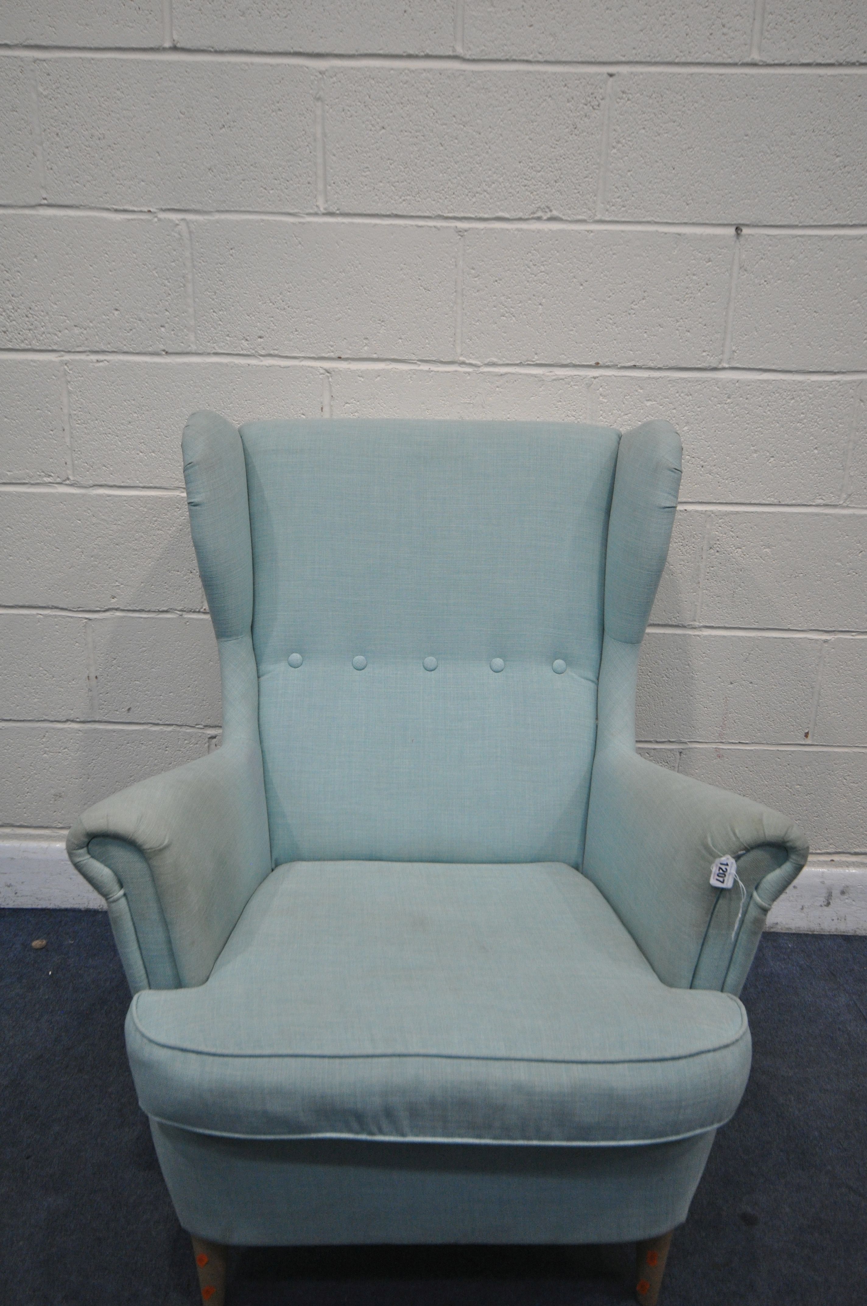 AN IKEA WINGBACK ARMCHAIR, with teal upholstery, width 83cm x depth 101cm x height 101cm (