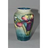 A MOORCROFT POTTERY BALUSTER VASE DECORATED IN THE ORCHID AND SPRING FLOWERS PATTERN, on a mottled