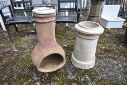 A VINTAGE TERRACOTTA CHIMINEA, with a painted lid on a wire stand, diameter 40cm x height 74cm,