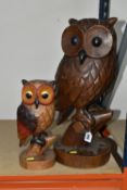 TWO LARGE CARVED WOODEN OWLS, comprising a solid wood painted owl, height 30cmm, together with a