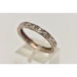 A WHITE METAL AND DIAMOND ETERNITY BAND RING, a flat profile band with a diamond cut pattern to