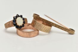 THREE 9CT GOLD RINGS AND A 9CT GOLD BAR BROOCH, the first a plain polished band ring , a textured