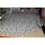 A GROUP OF CUT CRYSTAL DRINKING GLASSES, comprising a set of twelve wine glasses, a set of twelve