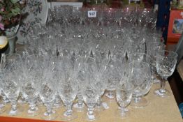 A GROUP OF CUT CRYSTAL DRINKING GLASSES, comprising a set of twelve wine glasses, a set of twelve