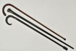 A COLLECTION OF THREE WALKING STICKS, the first an ebonised stick, fitted with a silver pommel,