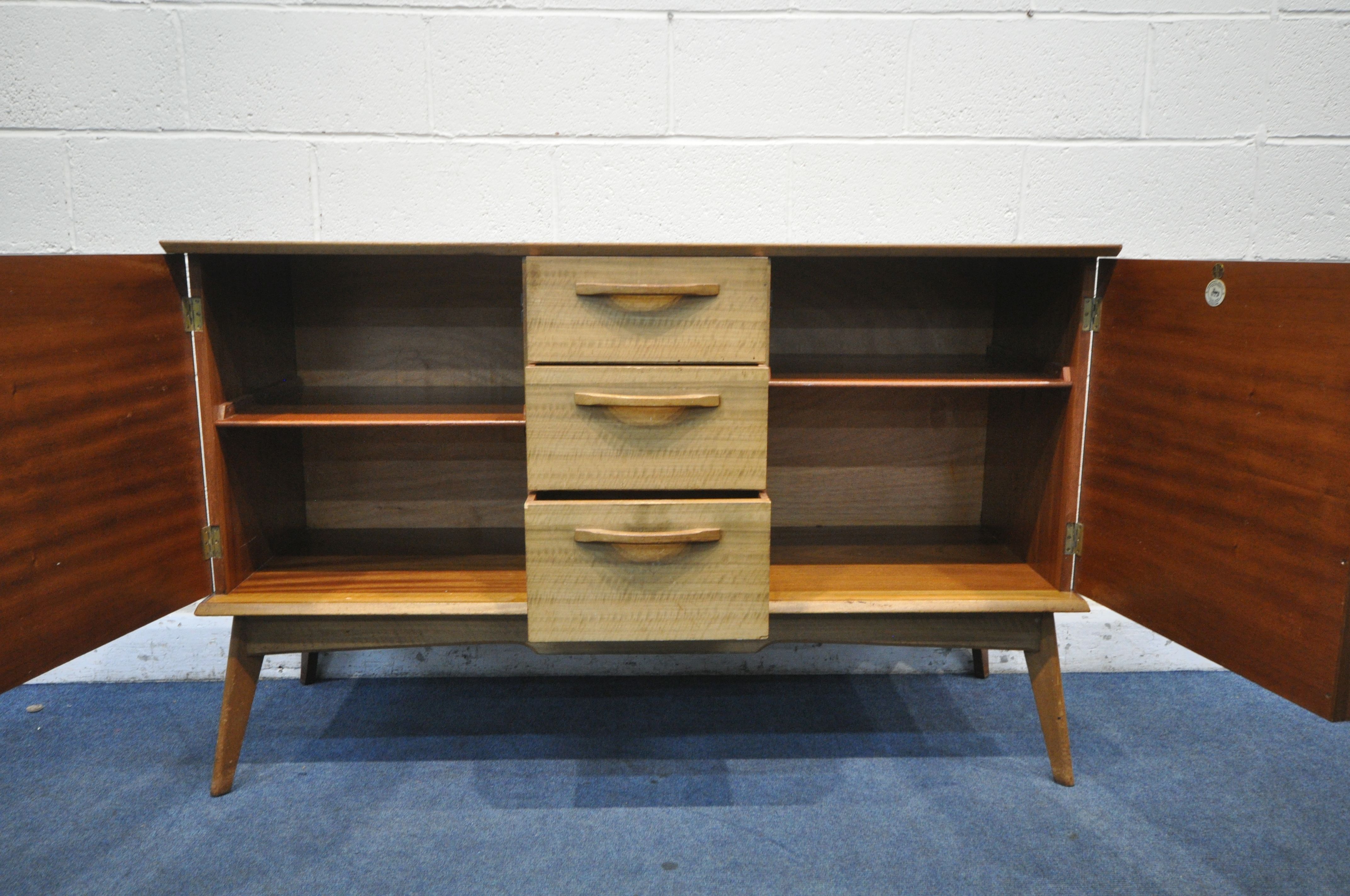 A MID CENTURY ALFRED COX TEAK SIDEBOARD, with two cupboard doors, flanking three drawers, the top - Image 4 of 7