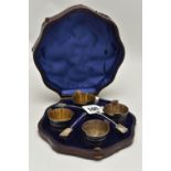 A CASED SET OF LATE VICTORIAN SILVER SALTS, case opens to reveal four salts in the form of buckets