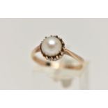 A SINGLE PEARL RING, a cultured pearl set in a yellow metal textured collet mount, leading onto a