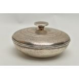 A SILVER LIDDED POT, of a circular form, engine turned pattern with round finial, brown plastic