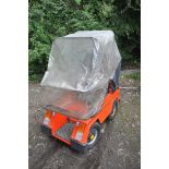 A CLASSIC 1984 VESSA TREKKA ORANGE MOBILITY SCOOTER, with rain cover and charger (untested) (
