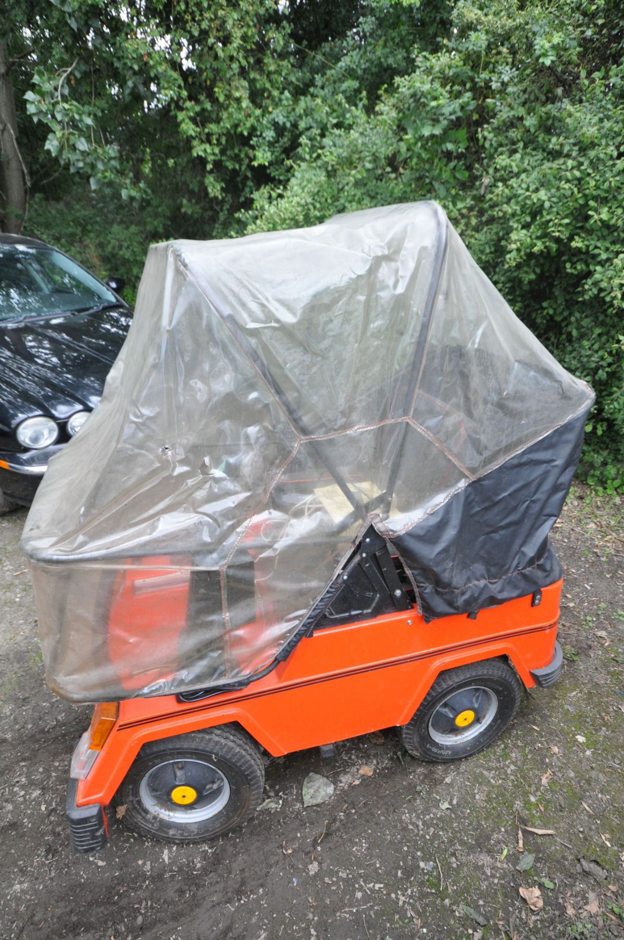 A CLASSIC 1984 VESSA TREKKA ORANGE MOBILITY SCOOTER, with rain cover and charger (untested) ( - Image 2 of 6