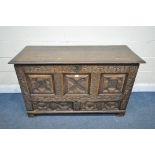 A GEORGIAN AND LATER CARVED OAK PANELLED MULE CHEST, the front with geometric panels, foliate