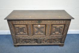 A GEORGIAN AND LATER CARVED OAK PANELLED MULE CHEST, the front with geometric panels, foliate