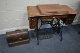 A VINTAGE SINGER TREADLE SEWING MACHINE, along with an oak cased singer sewing machine (condition