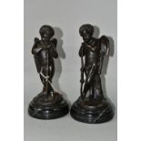 A PAIR OF BRONZE SCULPTURES OF CUPID, depicted resting on his bow, each indistinctly signed, on