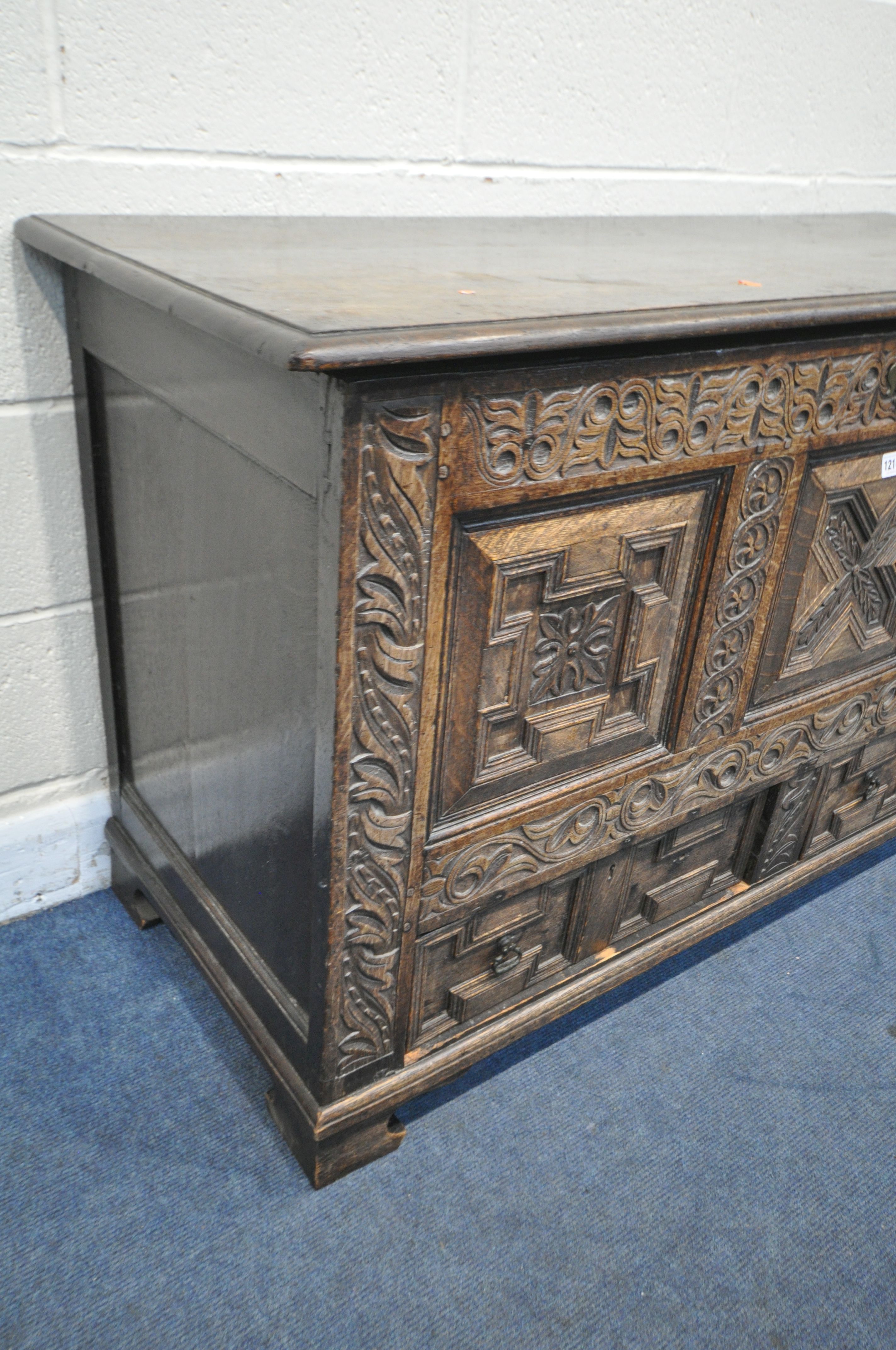 A GEORGIAN AND LATER CARVED OAK PANELLED MULE CHEST, the front with geometric panels, foliate - Image 2 of 4