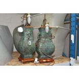 A PAIR OF TABLE LAMPS, bronzed style lamp bases with pale green shades, height 65cm to top of