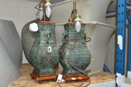A PAIR OF TABLE LAMPS, bronzed style lamp bases with pale green shades, height 65cm to top of