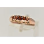 A 9CT GOLD AND GARNET FIVE STONE RING, five circular cut garnets, prong set in yellow gold,
