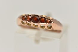 A 9CT GOLD AND GARNET FIVE STONE RING, five circular cut garnets, prong set in yellow gold,