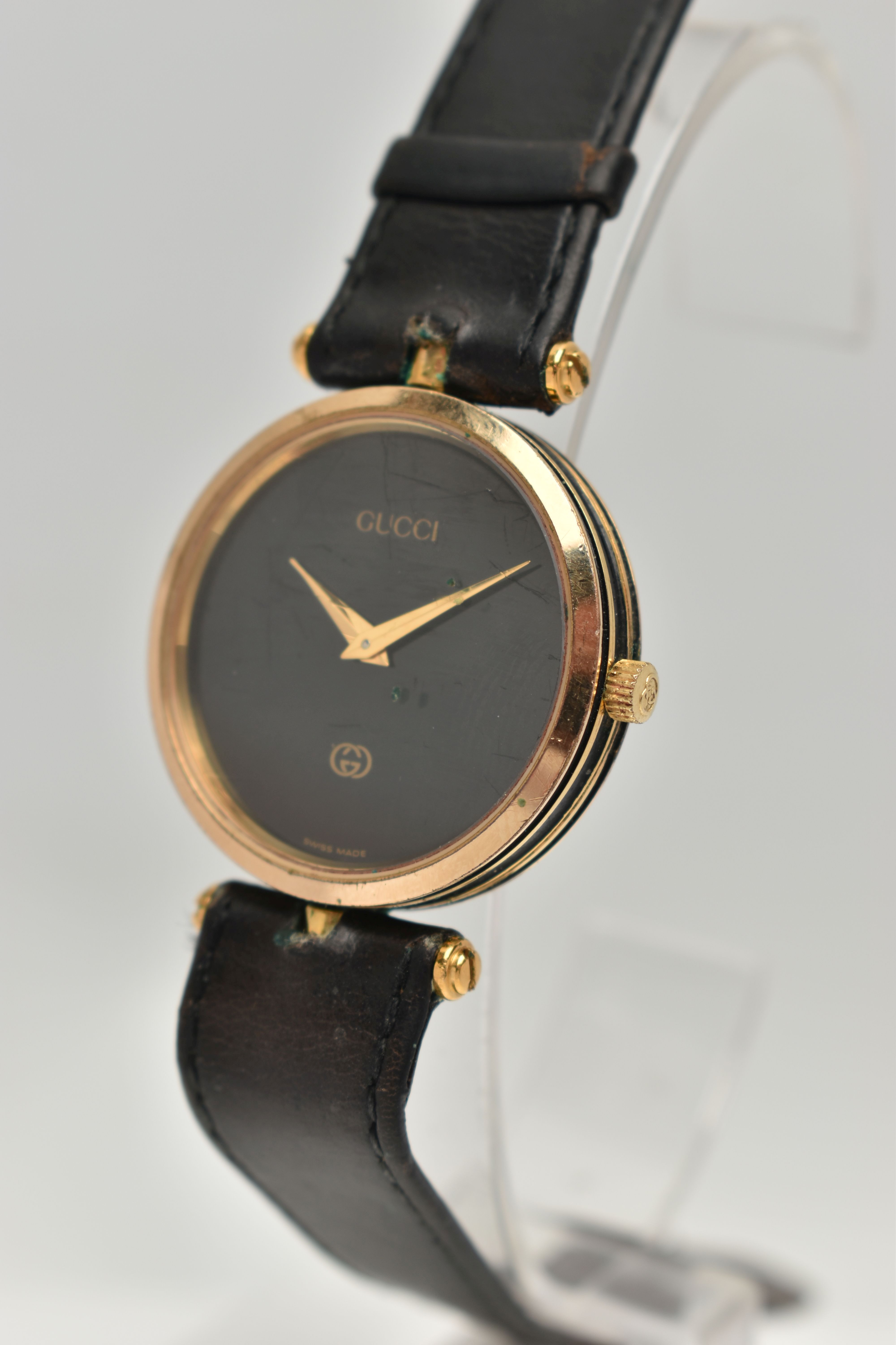 A VINTAGE LADYS GOLD PLATED QUARTZ GUCCI WRISTWATCH, round black dial signed Gucci, case width - Image 3 of 6