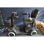 AN INVACARE LEO MOBILITY SCOOTER with charger (battery flat, does not appear to charge) and a box