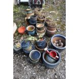 A LARGE SELECTION OF SMALL GLAZED PLANT POTS, to include blue, green, brown, etc, a small watering