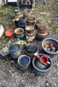 A LARGE SELECTION OF SMALL GLAZED PLANT POTS, to include blue, green, brown, etc, a small watering