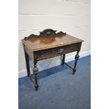 AN EARLY 20TH CENTURY CARVED OAK SIDE TABLE, with mask detail, raised back and a single drawer,