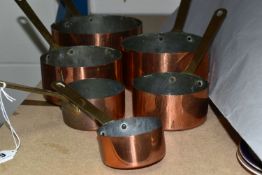 A GROUP OF SIX GRADUATED COPPER PANS, brass handles (6) (Condition Report: no maker's mark, appear